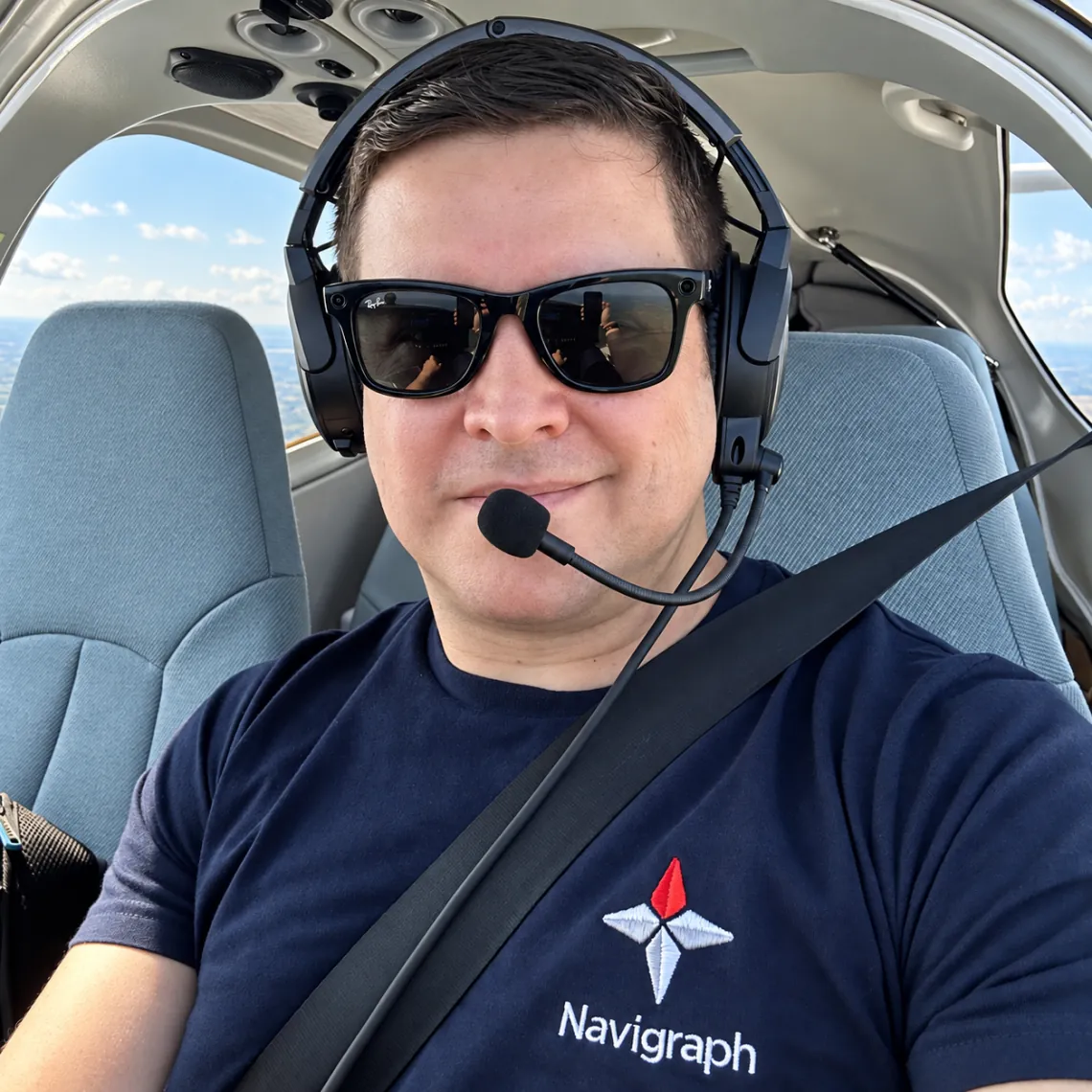 Flight Streamer wearing sunglasses and an aviation headset in an aircraft cockpit