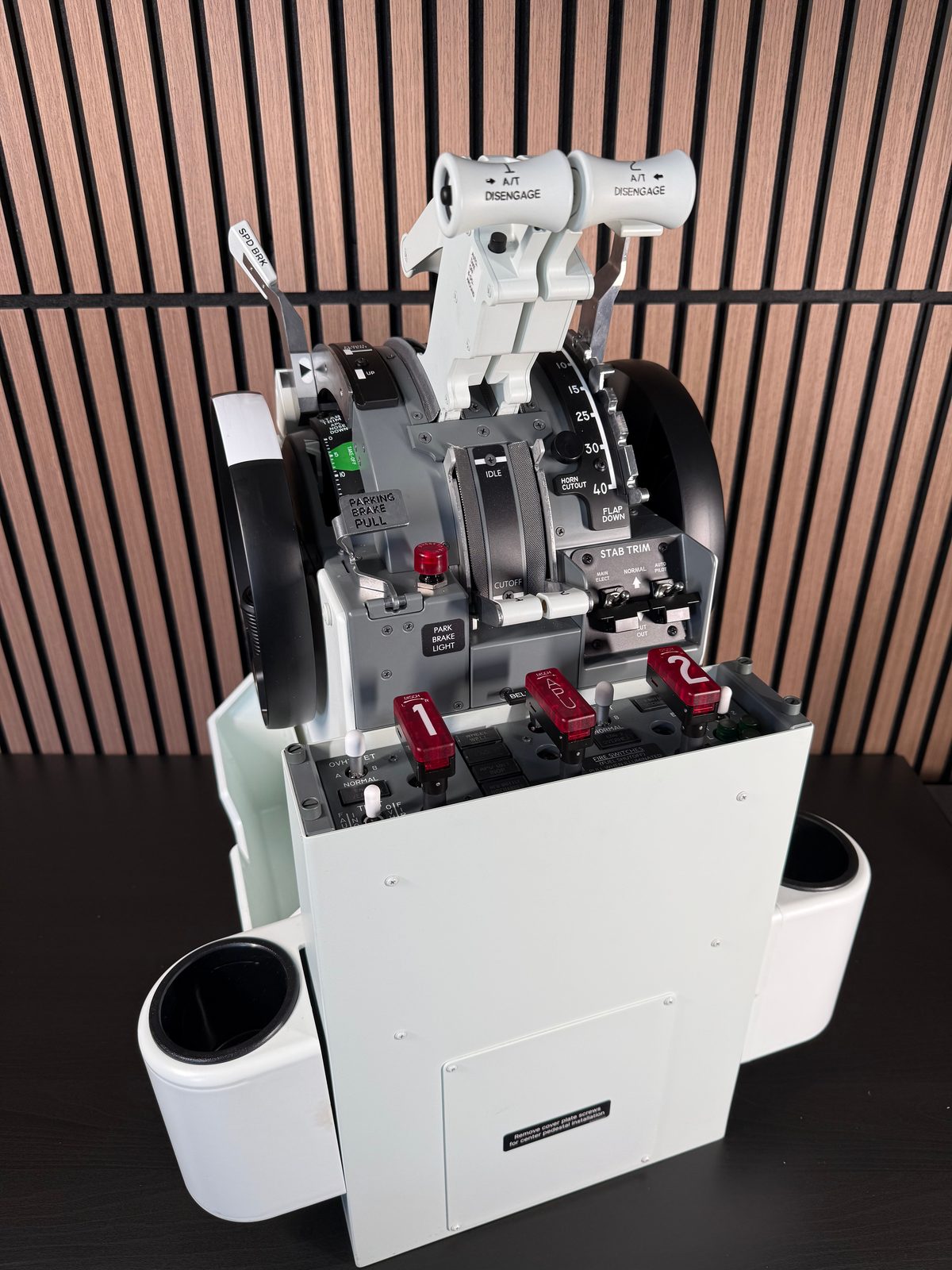 Front view of the CS 737 TQ on its white pedestal with integrated fire handles and side cup holders.
