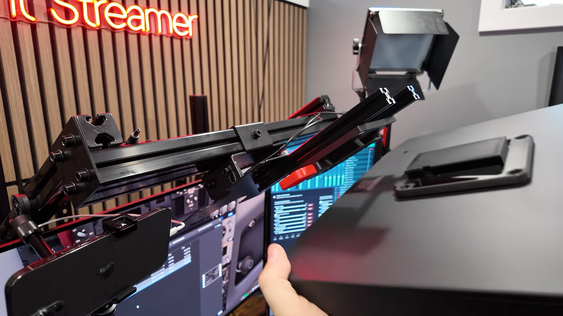 Rear mounting view of the Rowsfire B107 attached to a VESA-style support arm in a home cockpit